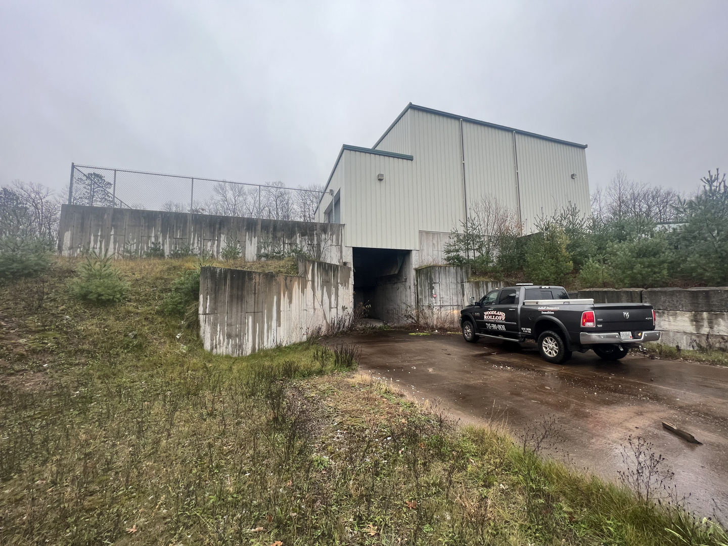 Woodland Rolloff truck at transfer station concrete retaining walls