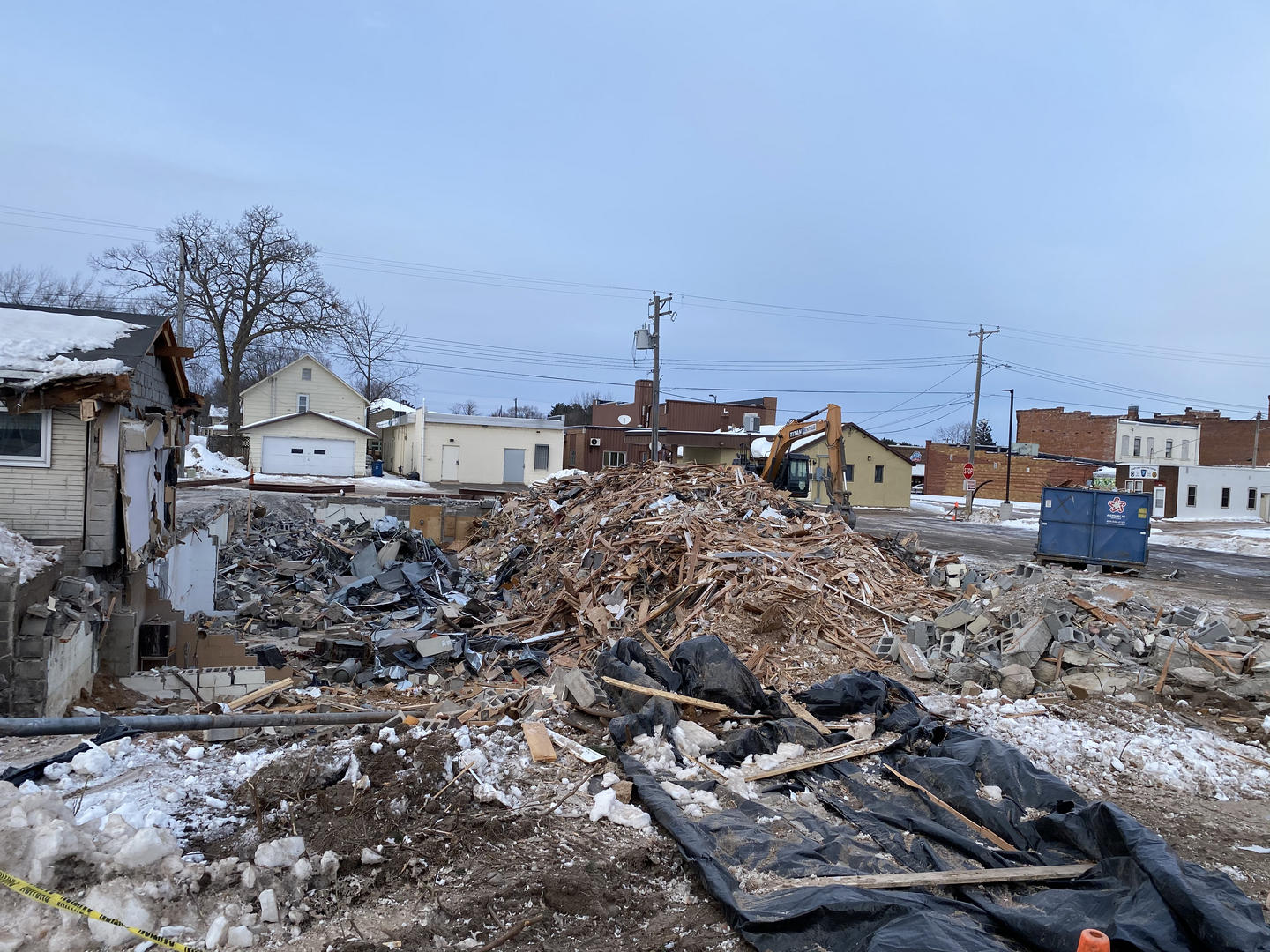 Shell Lake Clinic demolition debris pile with excavator