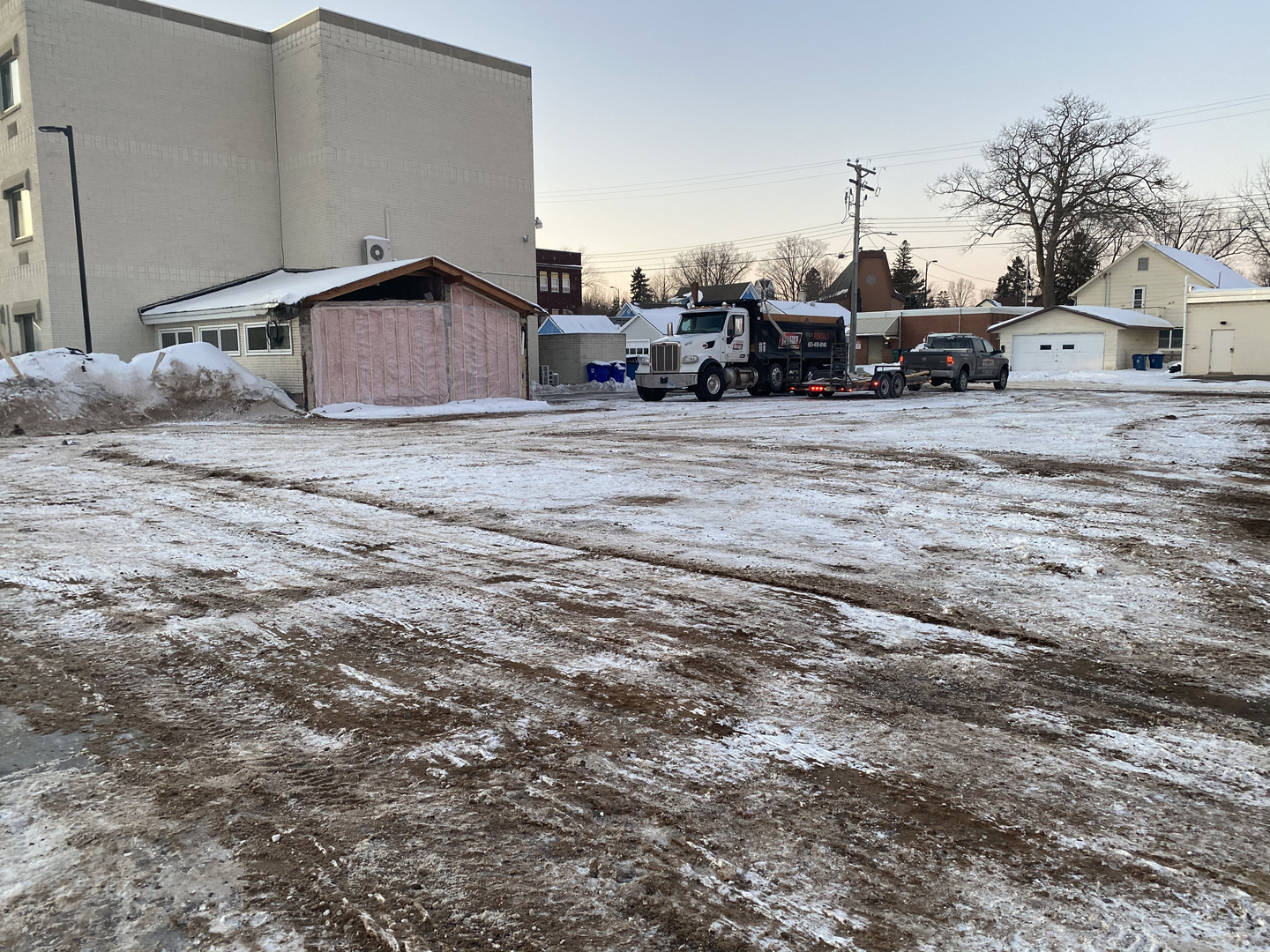 Commercial building demolition site with Woodland Rolloff dump truck