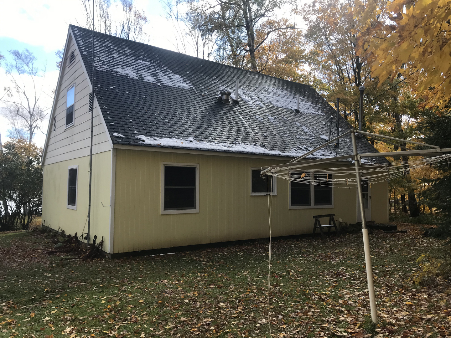 Yellow main house with green roof on Lake Namakagon before demolition