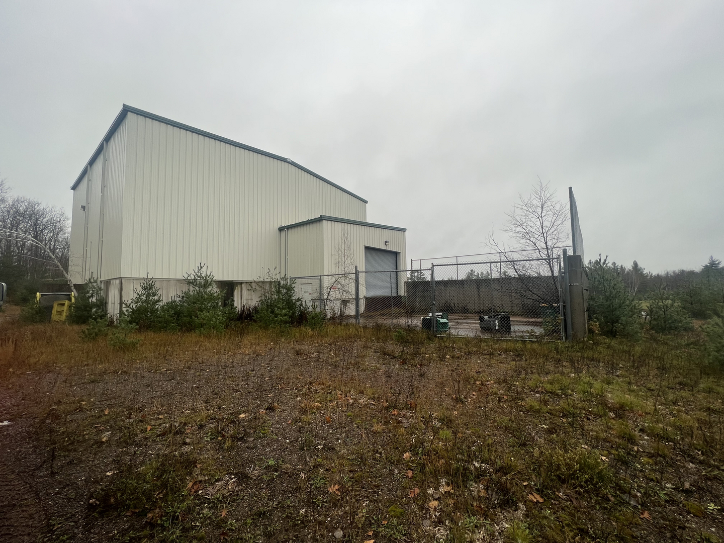 Transfer station building side view with chain link fence