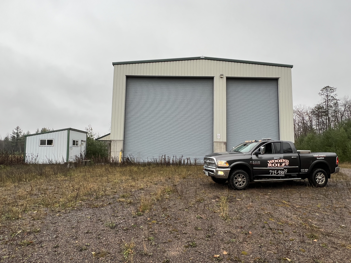 Woodland Rolloff truck parked at transfer station building before renovation