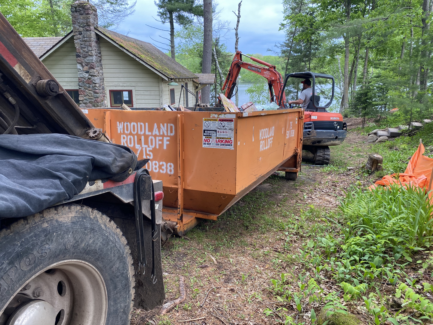 Kubota excavator loading Woodland Rolloff dumpster