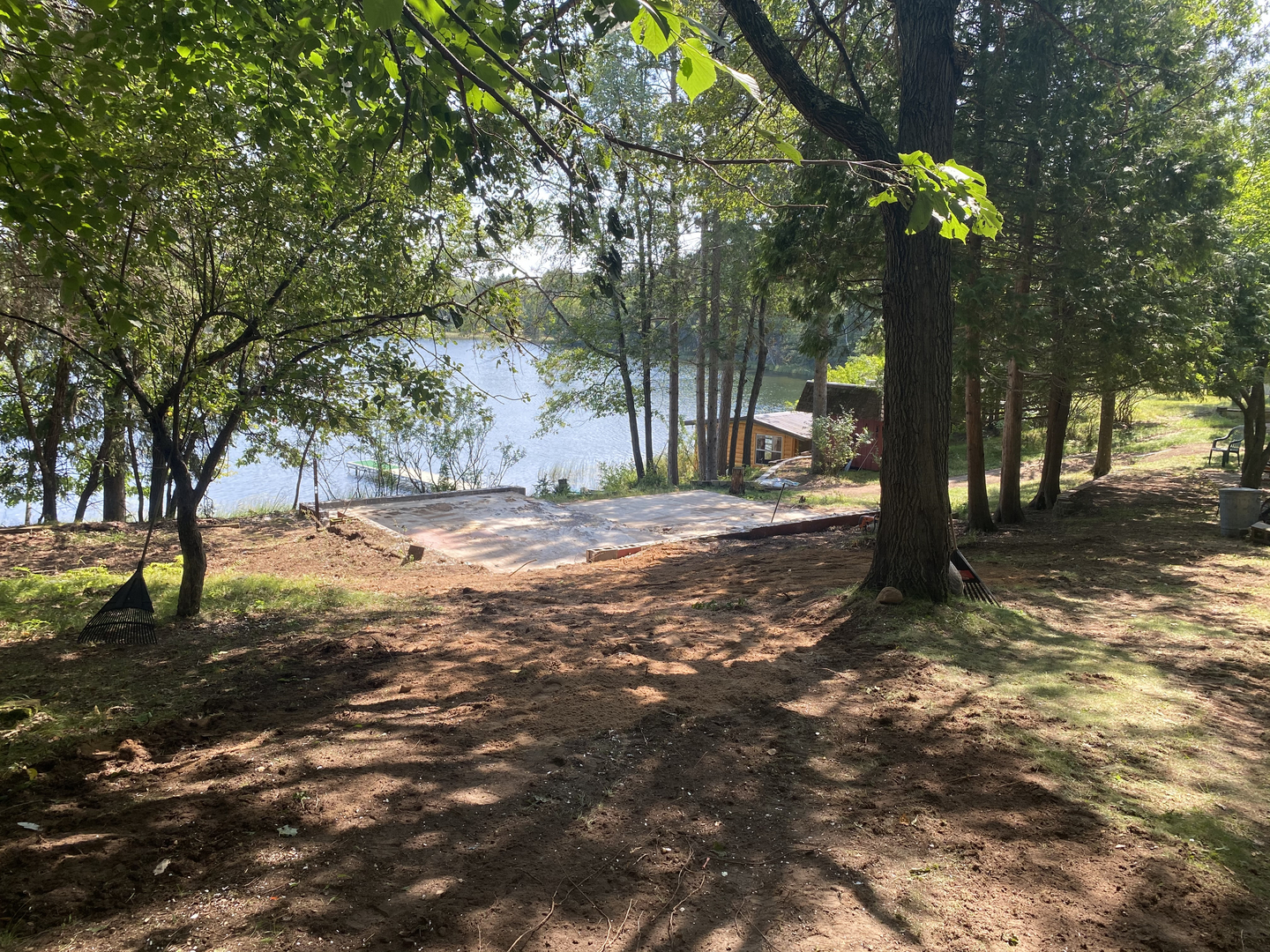 Cleared foundation slab after cabin demolition on lake