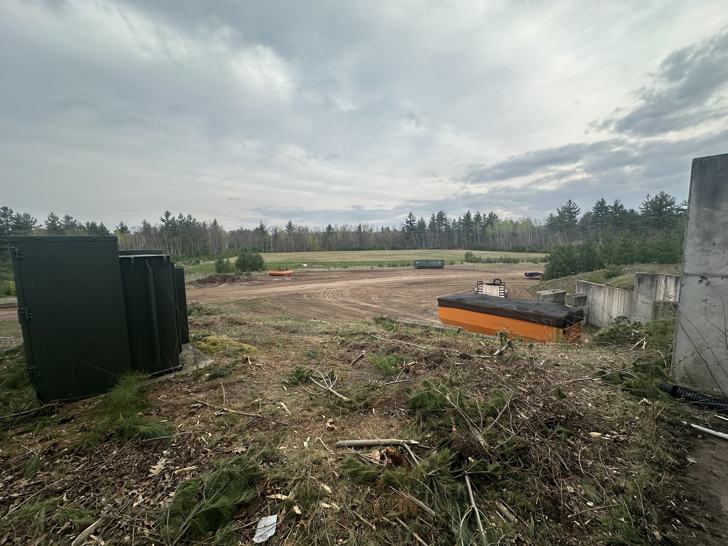 Transfer station site overview with orange dumpster and equipment