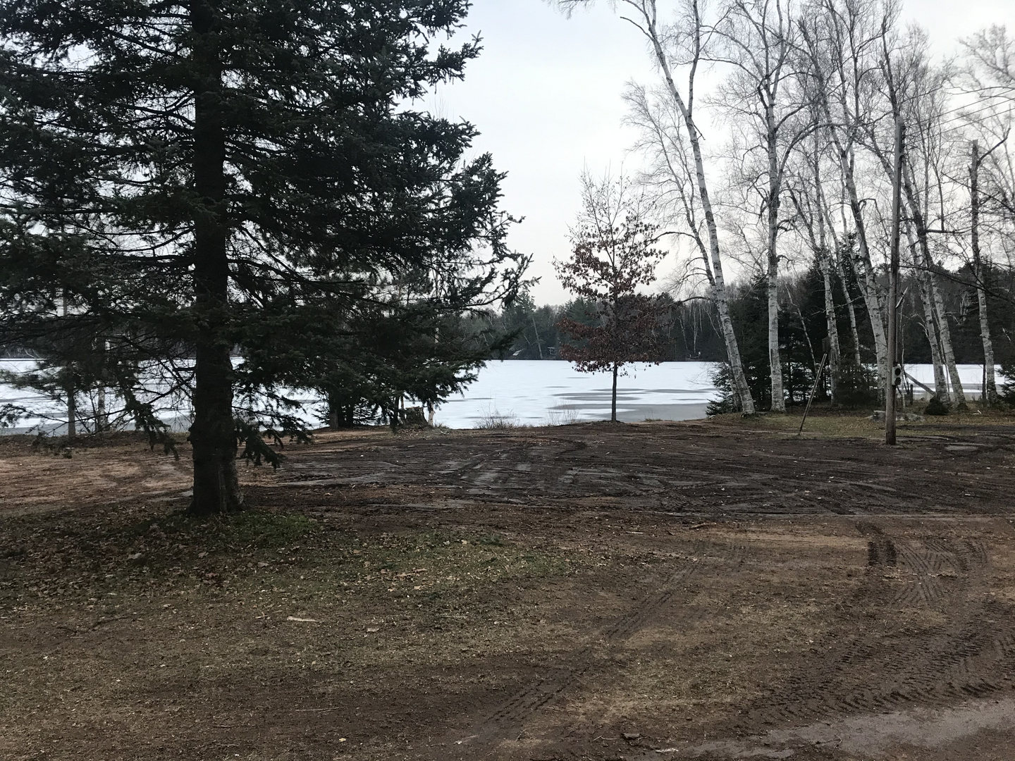 Cleared lakeside lot after structure demolition in winter