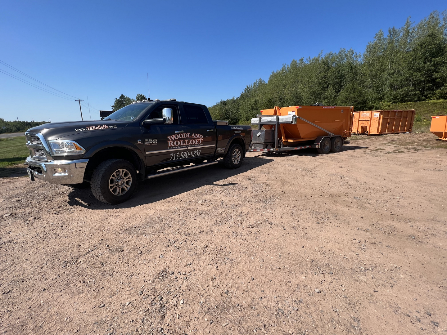 Woodland Rolloff Ram truck towing dumpster trailer