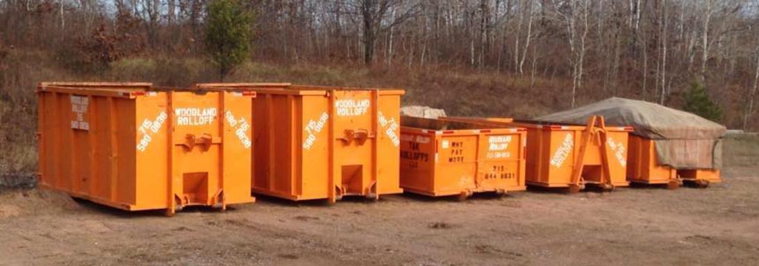 Orange rolloff dumpsters lineup – click for dumpster information